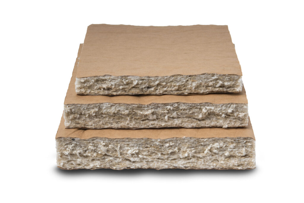 Stack of mineral wool insulation boards with brown cardboard spacers between layers.